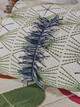 Embroidered cushion detail featuring dark indigo Trail Fringe trim over Mikado embroidered fabric, part of the Atelier Veronique collection by Christopher Farr Cloth. Photo by Christopher Horwood
